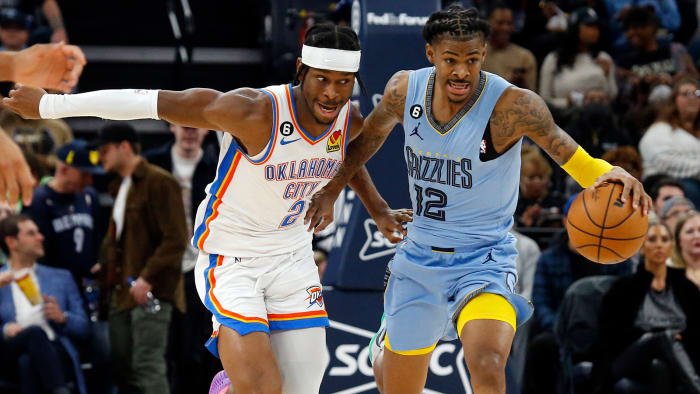 Memphis Grizzlies guard Ja Morant pushes the ball up the court as Oklahoma City Thunder guard Shai Gilgeous-Alexander.